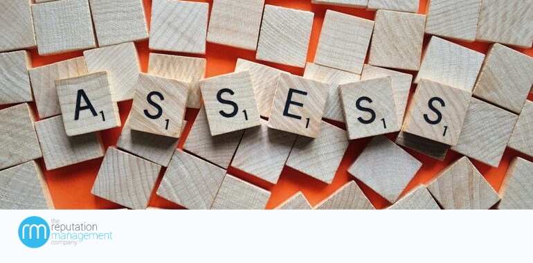 A picture of the word assess on it and a orange background behind it