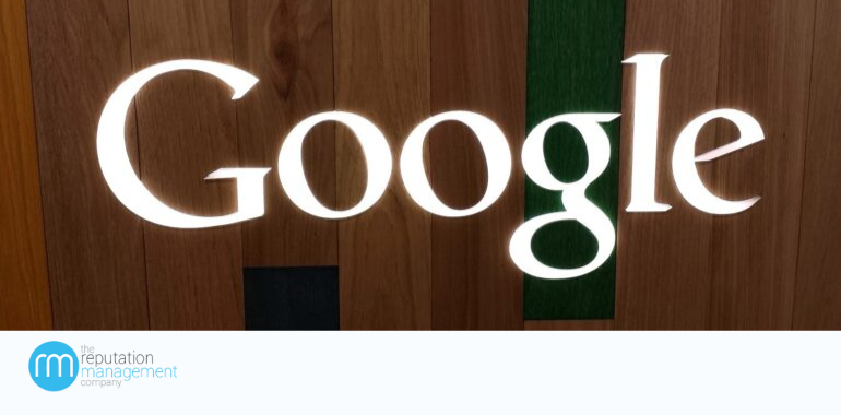 The word Google in white lettering with a wooden background